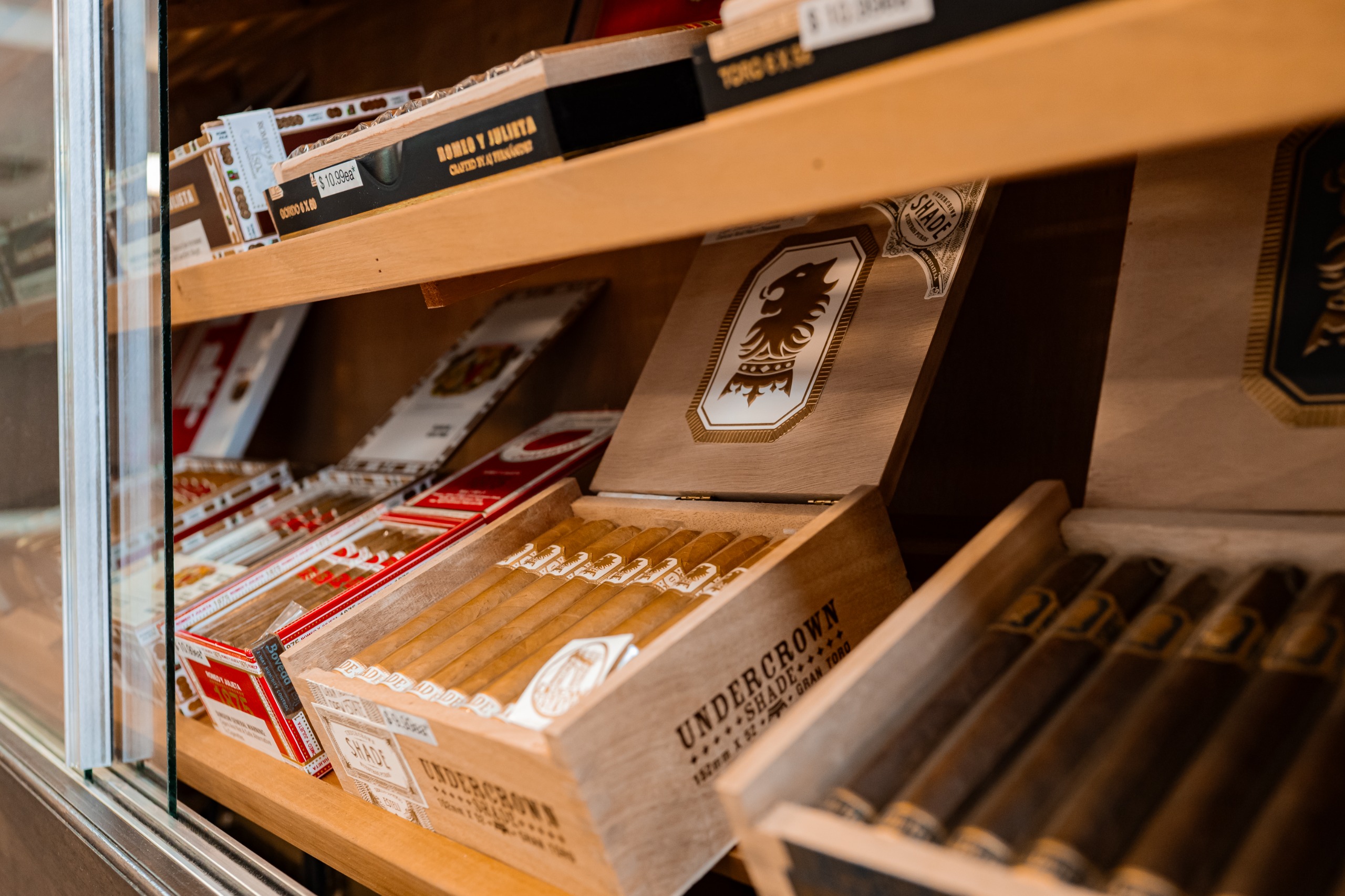 Close-up of cigars displayed in a humidor cabinet