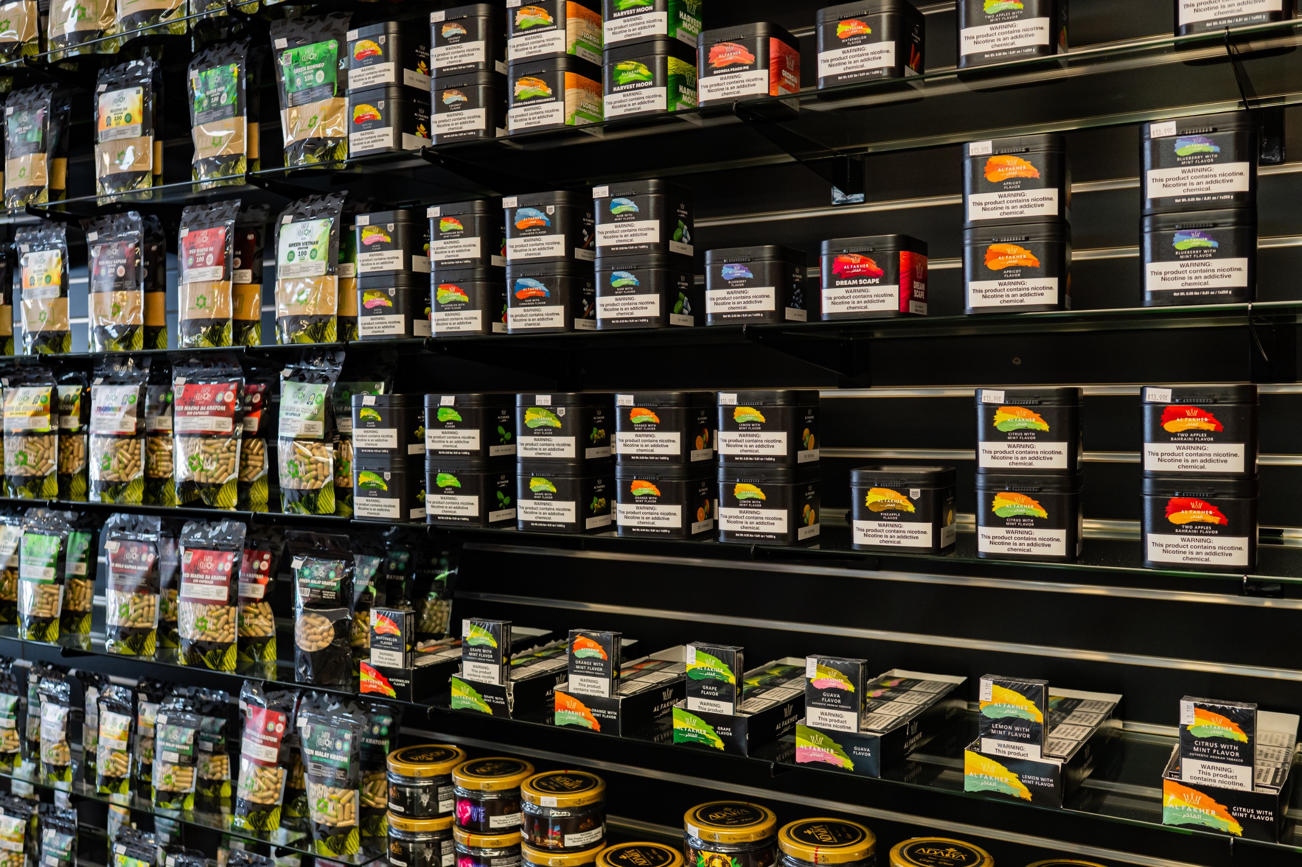 Hookah flavors and kratom products displayed on wall shelves